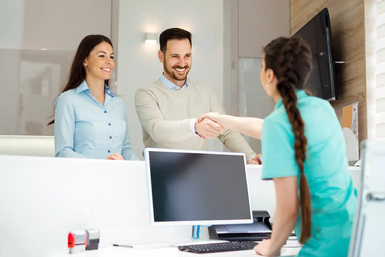 Front desk team welcoming patients